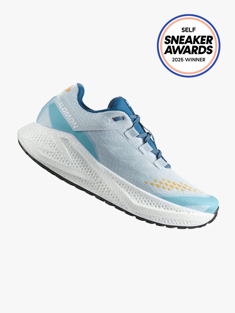Salomon Aero Glide 3 Sneaker in cool light blue tones with orange details. The SELF Sneaker Awards seal is in the top...